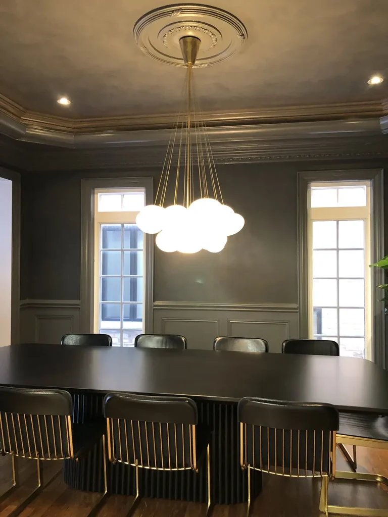 Brass cluster globe chandelier installed on a ceiling medallion in a formal dining room