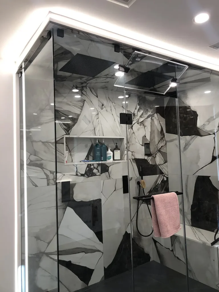 Glass shower with waterproof cove lighting and recessed shower pot lights