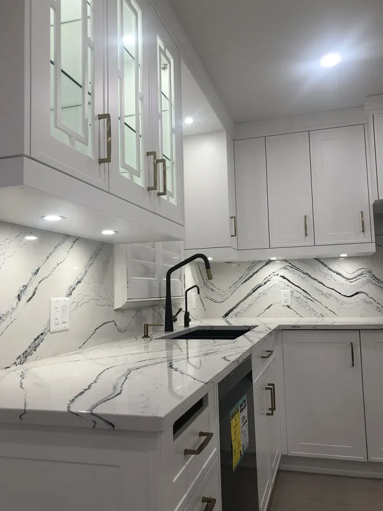 Kitchen with under-cabinet lighting and illuminated glass display cabinets