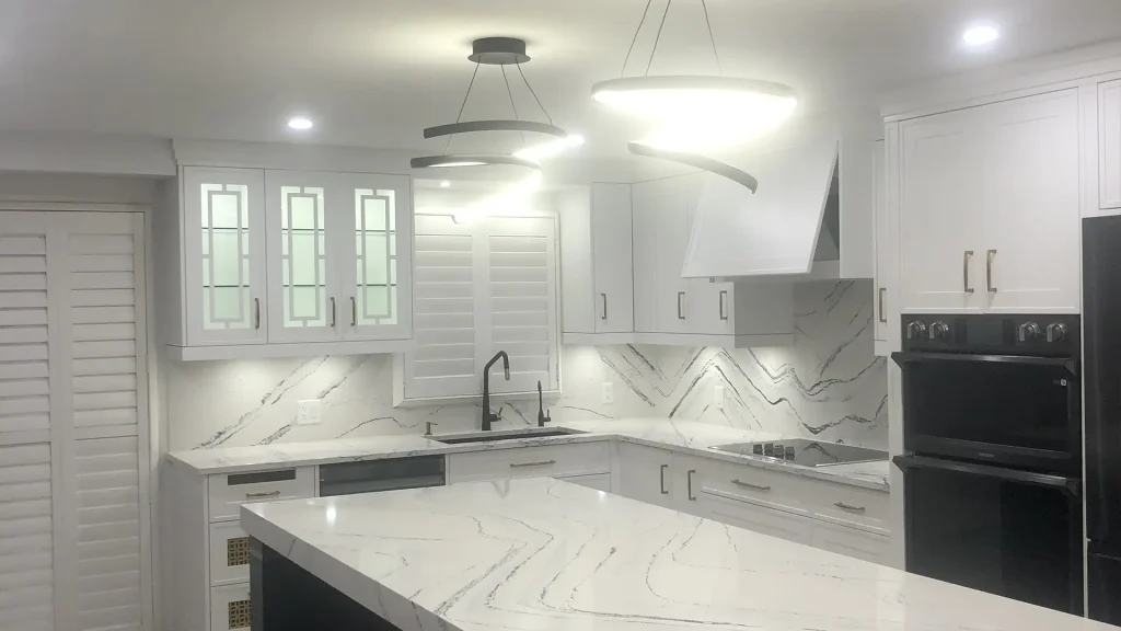 Kitchen with recessed pot lights and a flush-mount ceiling fixture after renovation
