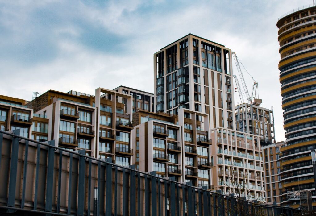 New condominium towers under construction with cranes overhead